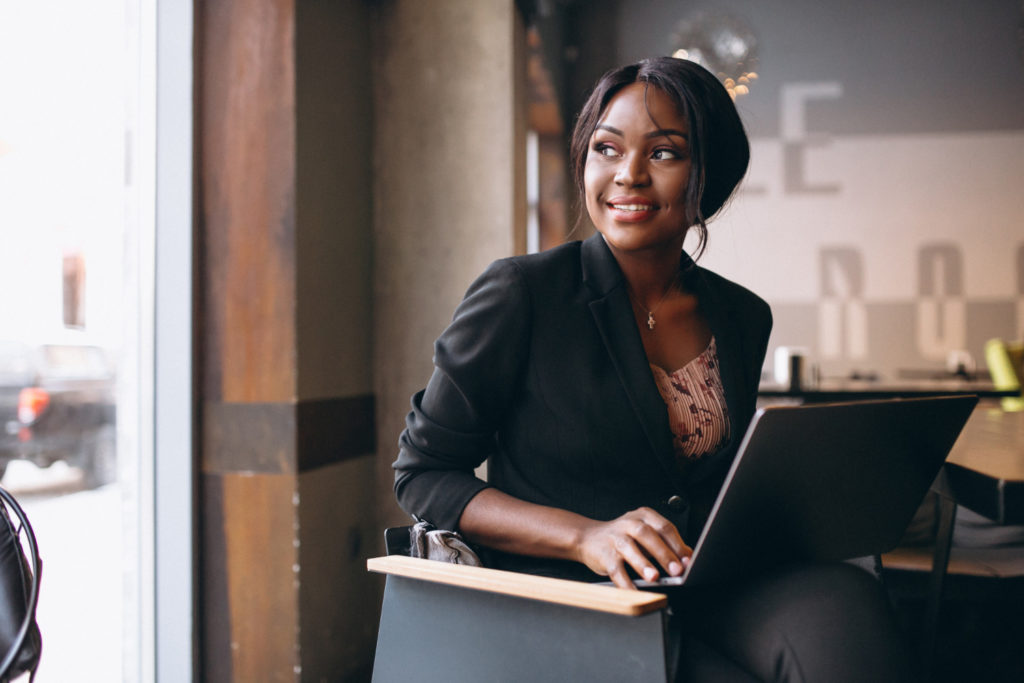 Black woman entrepreneur working on her laptop